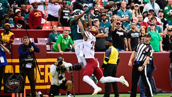 DeVonta Smith contests a catch in an Eagles game, with the Cali DFS Eliminator logo at lower left