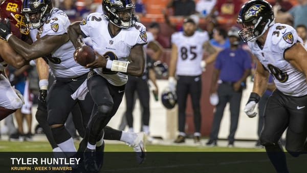 Tyler Huntley running with the football for Baltimore, archival game photo.